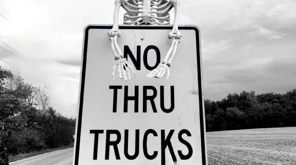 No thru trucks road sign with skeleton decoration in rural Lockbourne, Ohio